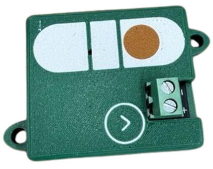 The Wonkometer sensor — a compact green Bluetooth board with a spirit-level graphic and a two-way screw terminal